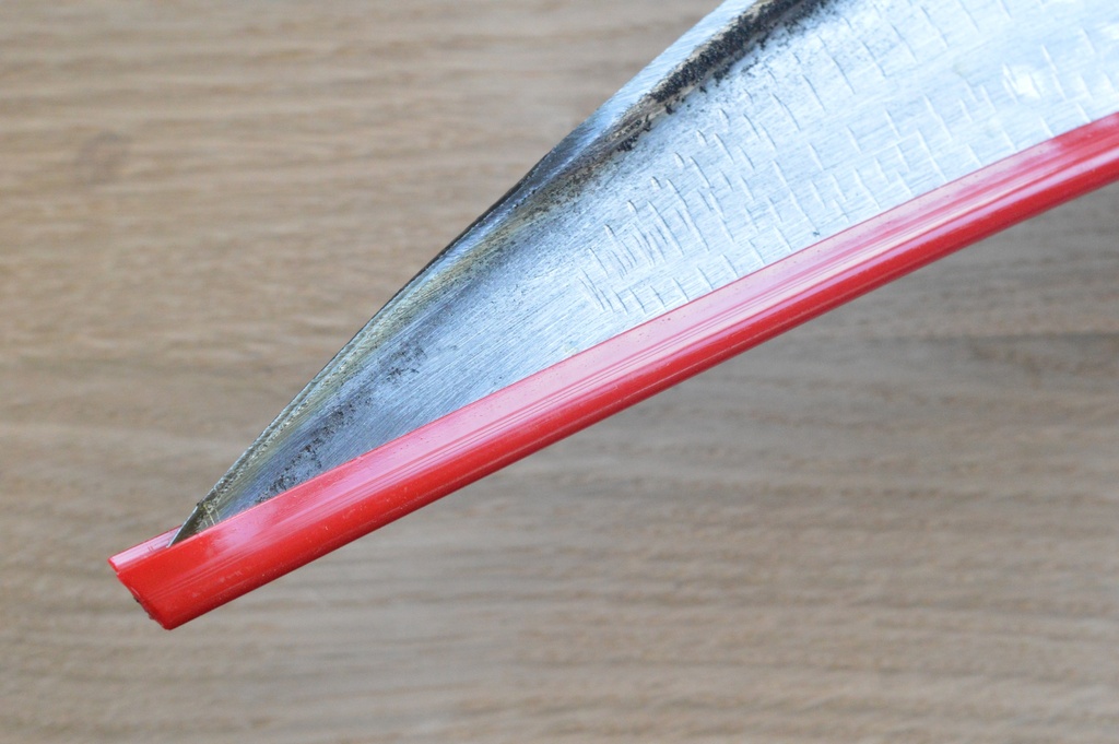 Plastic protective strip for scythe blades